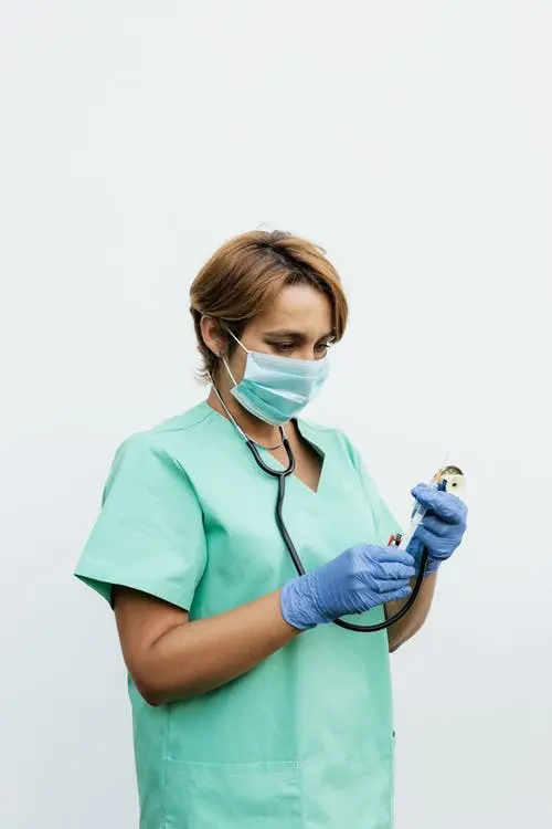 A doctor preparing a pneumonia shot.