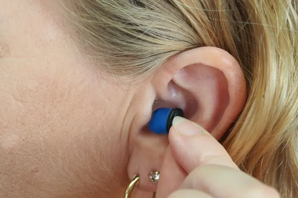 A woman with a hearing aid that was partially covered by her Supplement Plan.